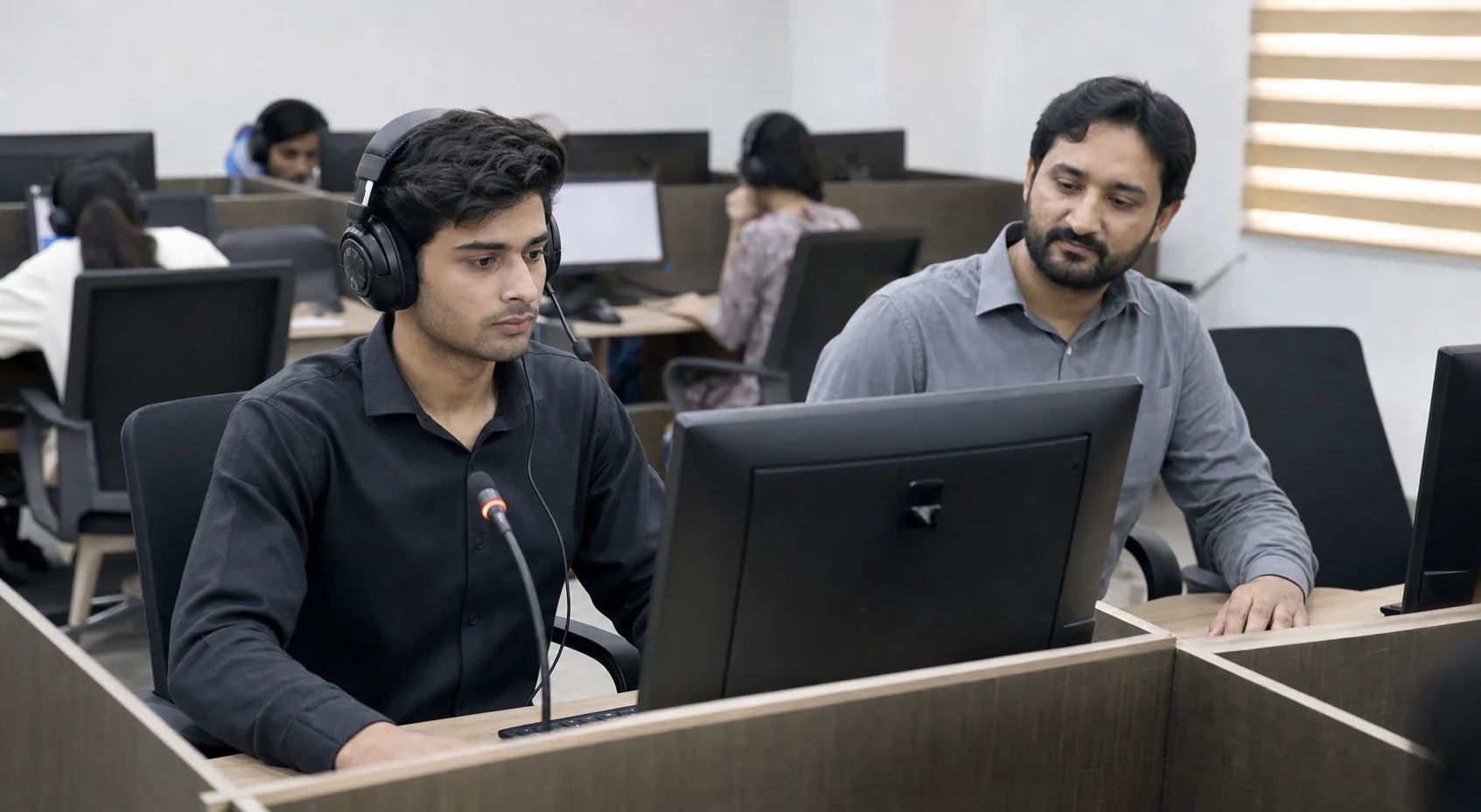 Pakistani student practising a computer-based PTE speaking task